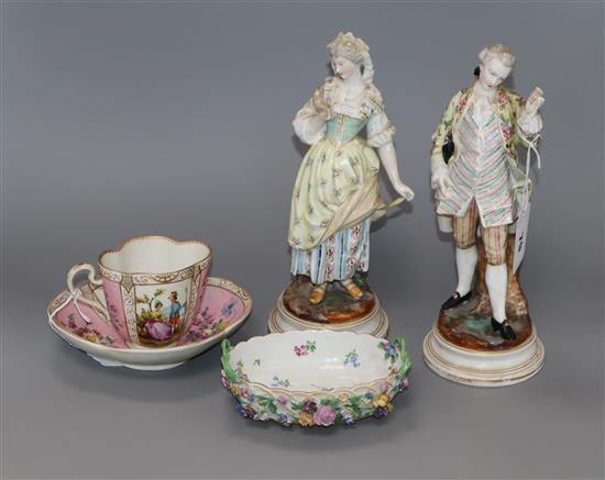 A pair of Dresden figures of a lady and gallant and a pink glazed cup and saucer and a dish tallest 24cm